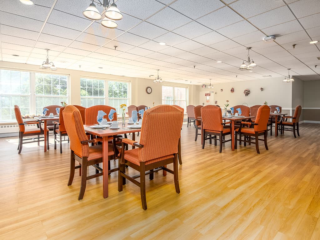 Bright dining room with tables set for meals