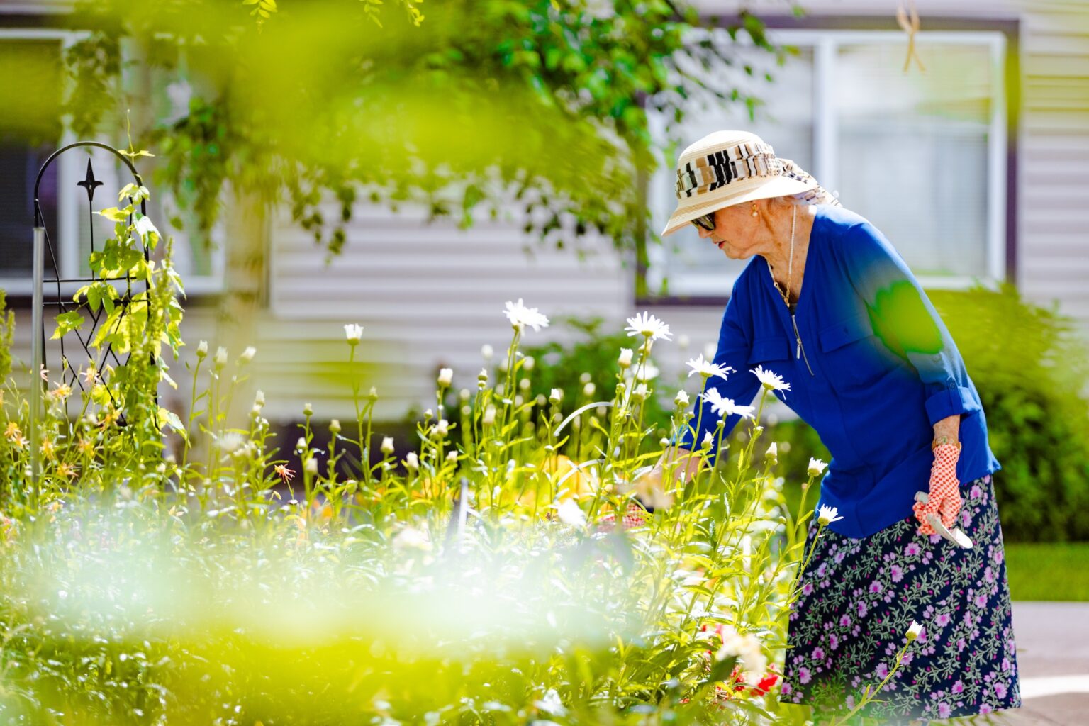 A resident gardening outdoors at the facility