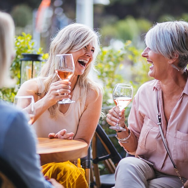 Two women enjoying drinks in an outdoor setting