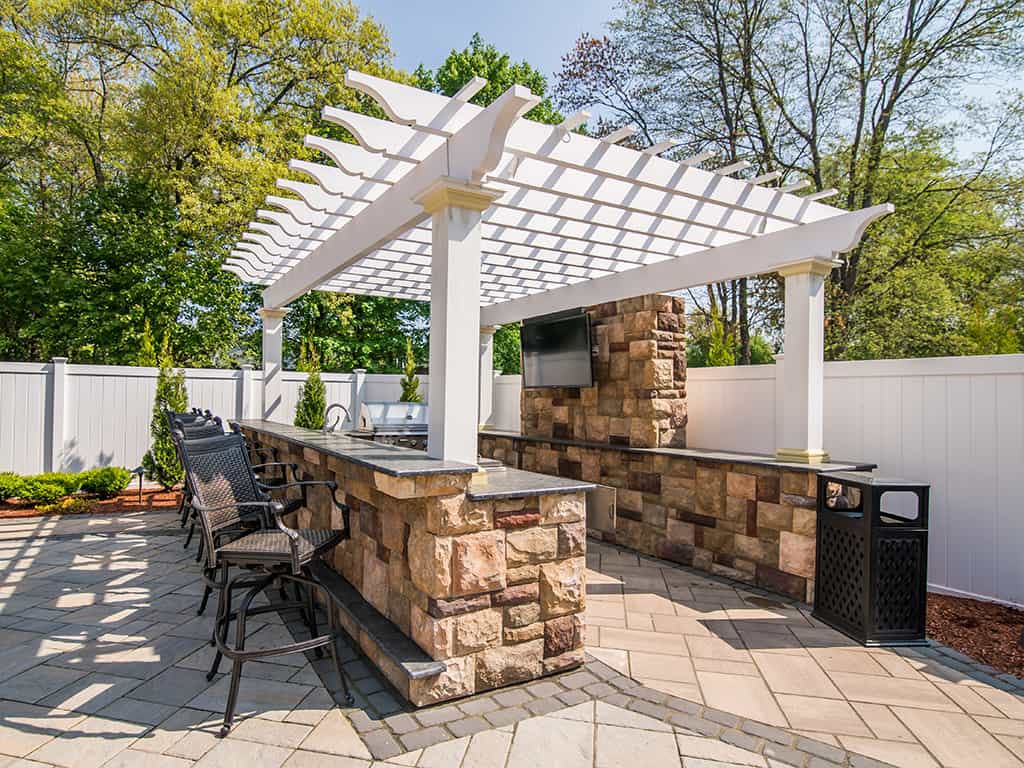 Outdoor bar area with seating and pergola