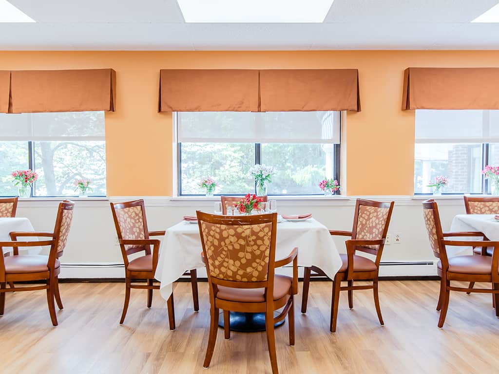 Dining area with tables and chairs set for a meal