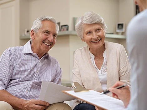 Couple smiling while reviewing documents together