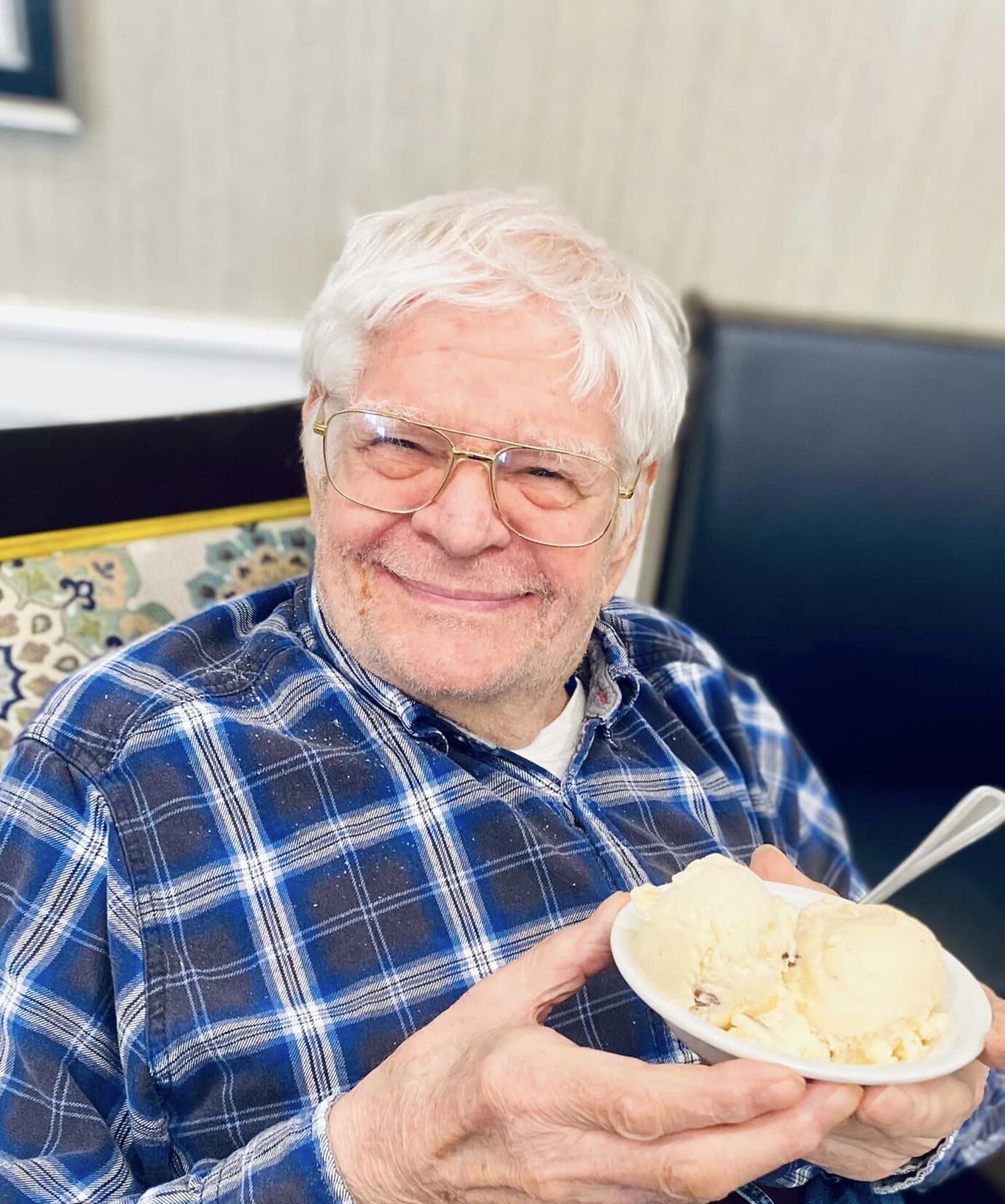 Senior resident enjoying ice cream in a common area