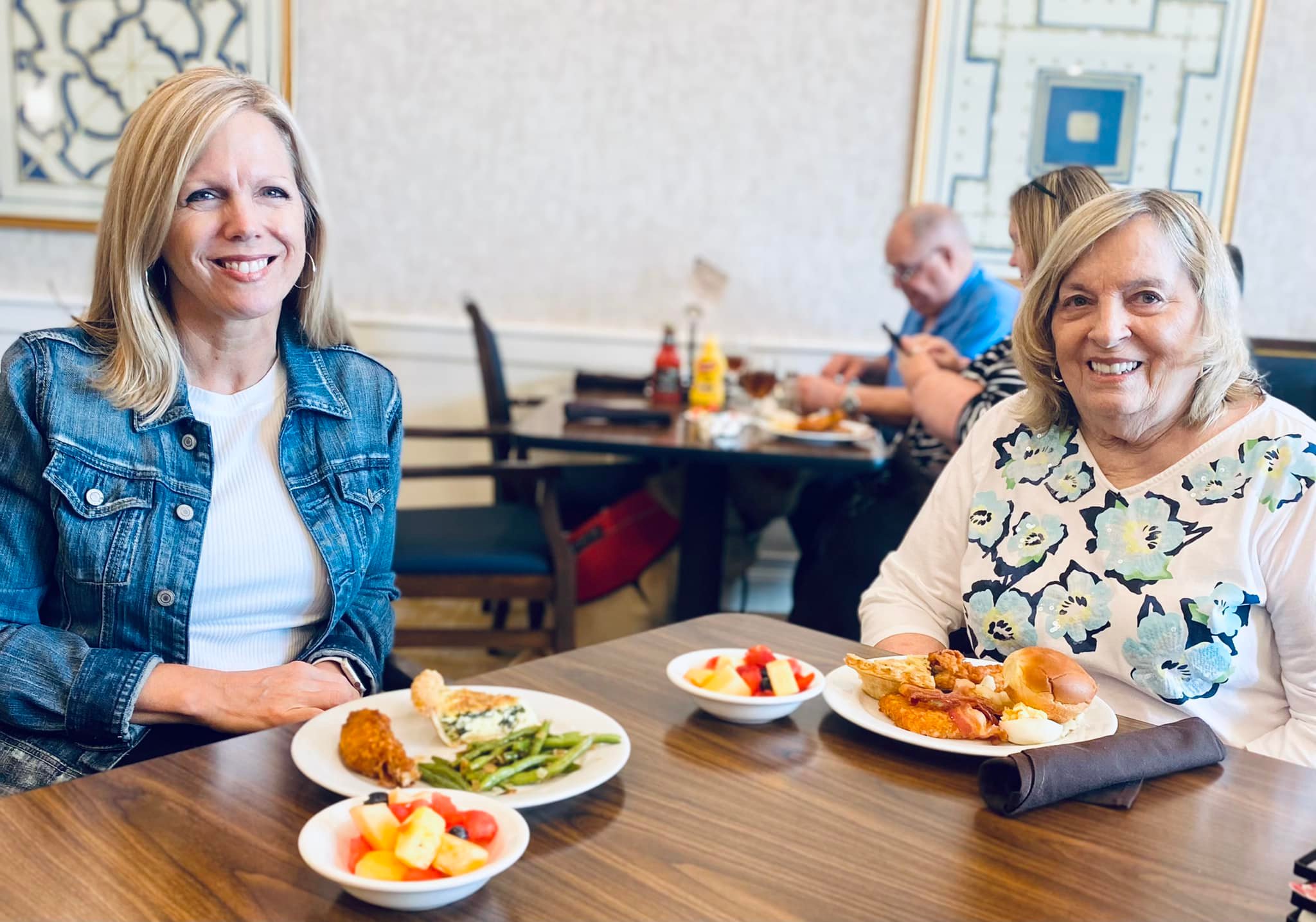 Two women enjoying a meal together in the dining room