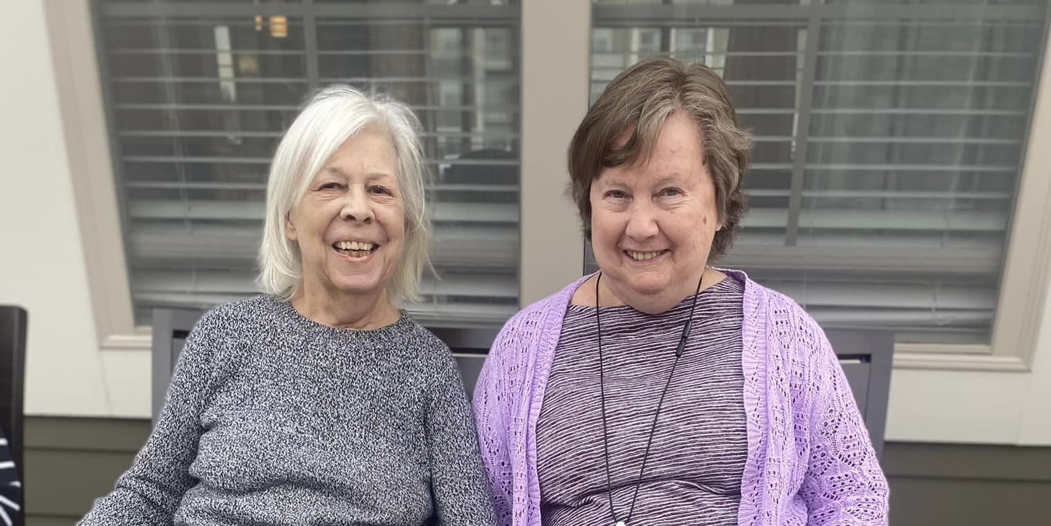Two smiling residents enjoying time together