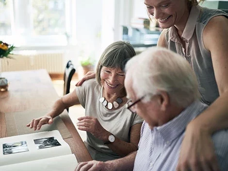 Residents enjoying time together while looking at a photo album