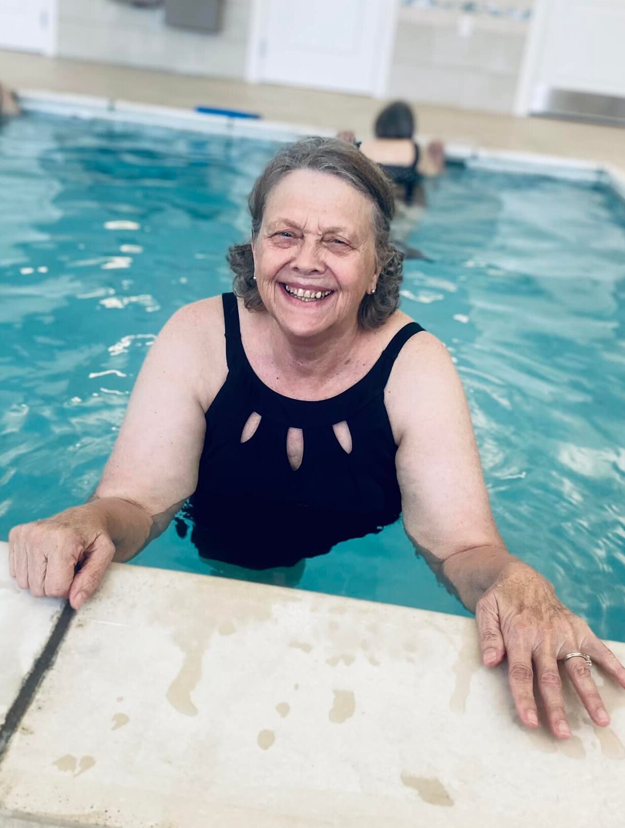 Resident enjoying a swim in an indoor pool