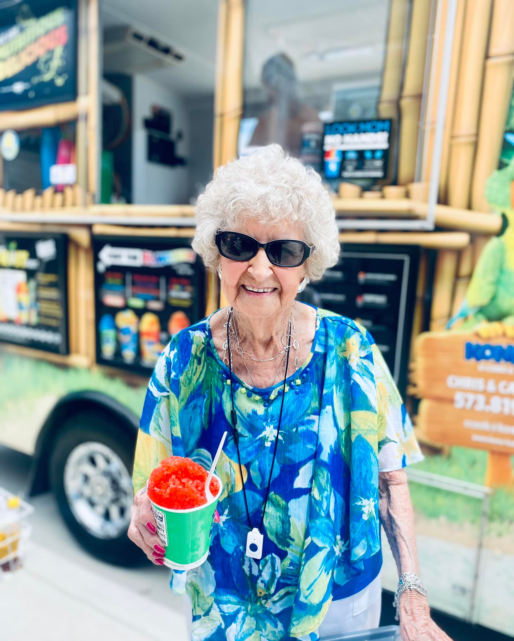 Senior woman enjoying a snow cone outside a food truck