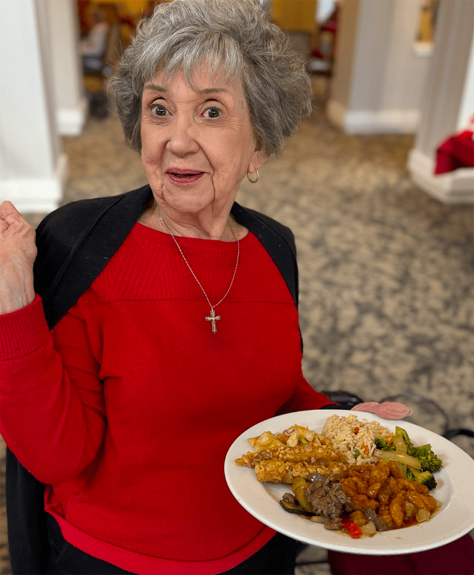 A resident enjoying a meal in the dining area