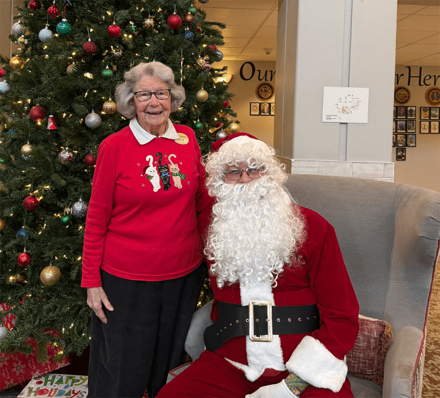 Resident and Santa Claus pose for a holiday photo