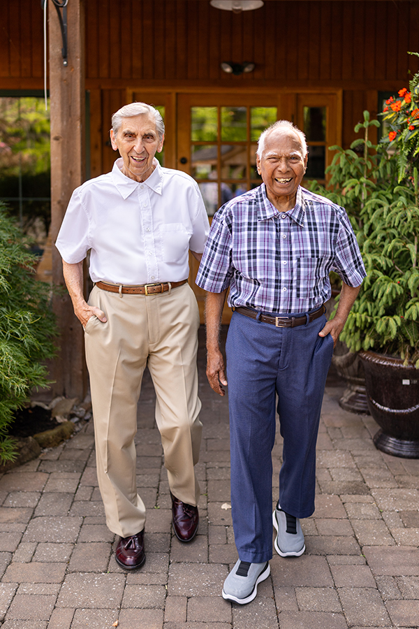 Two residents smiling in a garden area