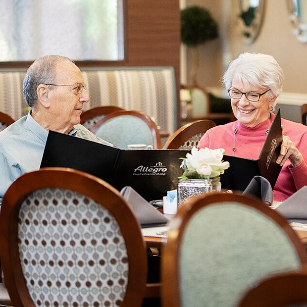 Two residents enjoying a meal in the dining room