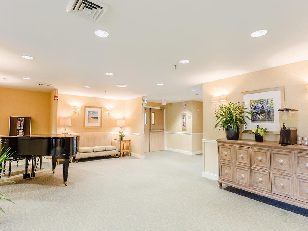 Bright common area with piano and seating
