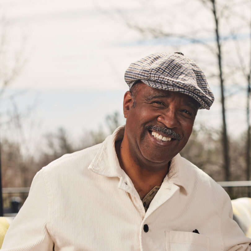 Smiling elderly man wearing a cap outdoors