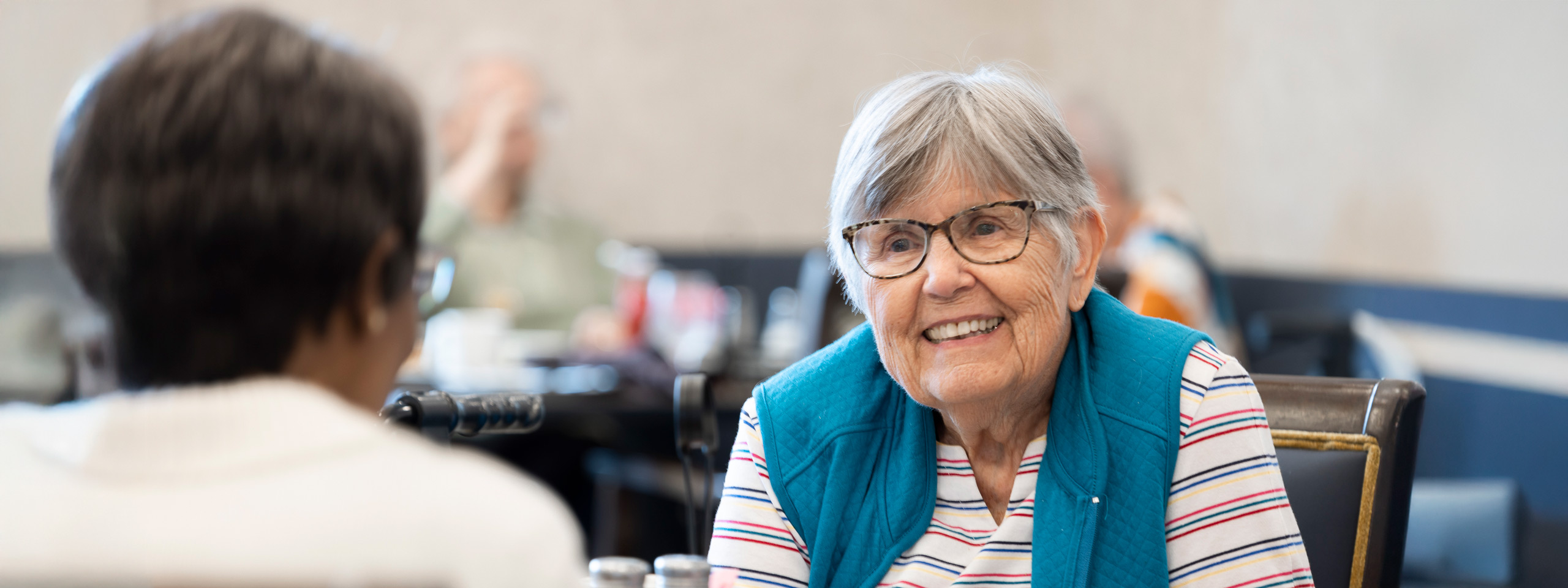 Two residents engaged in conversation in a common area