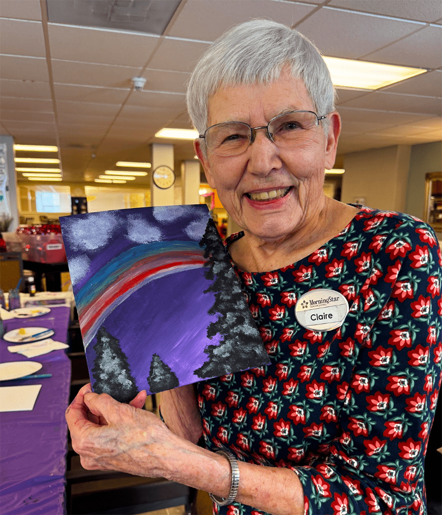 Resident enjoying an art activity in a common area