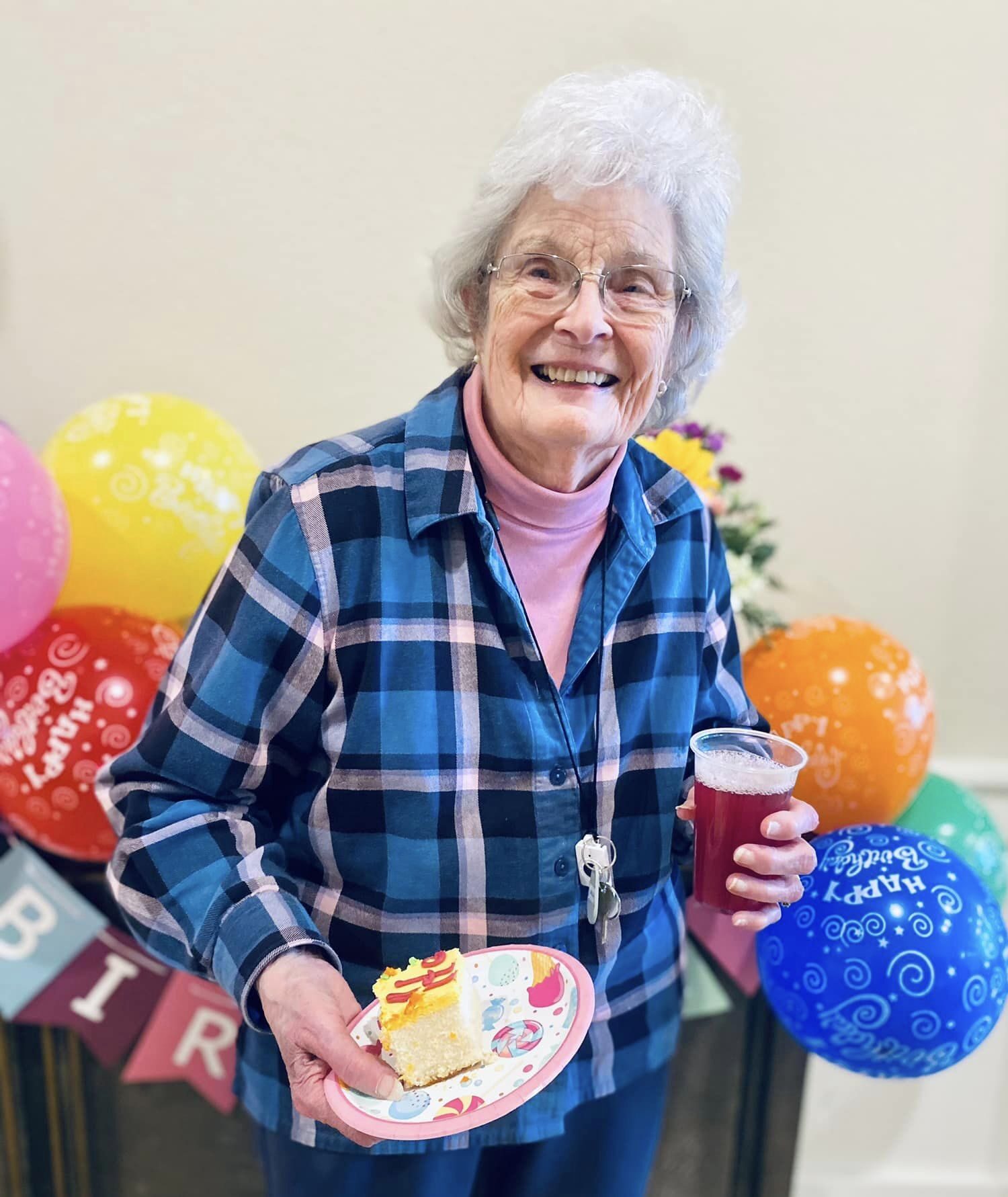 Resident celebrating with birthday cake and drink