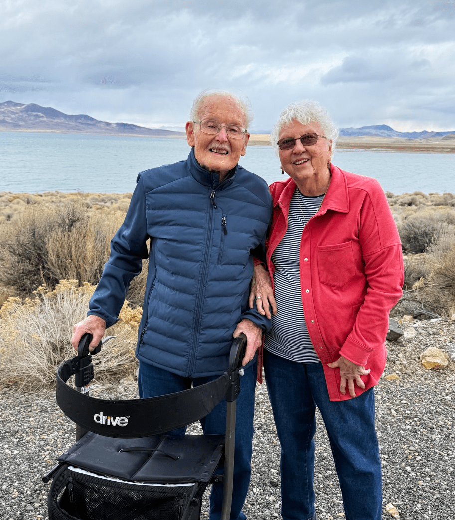 Two residents posing outdoors by the lake