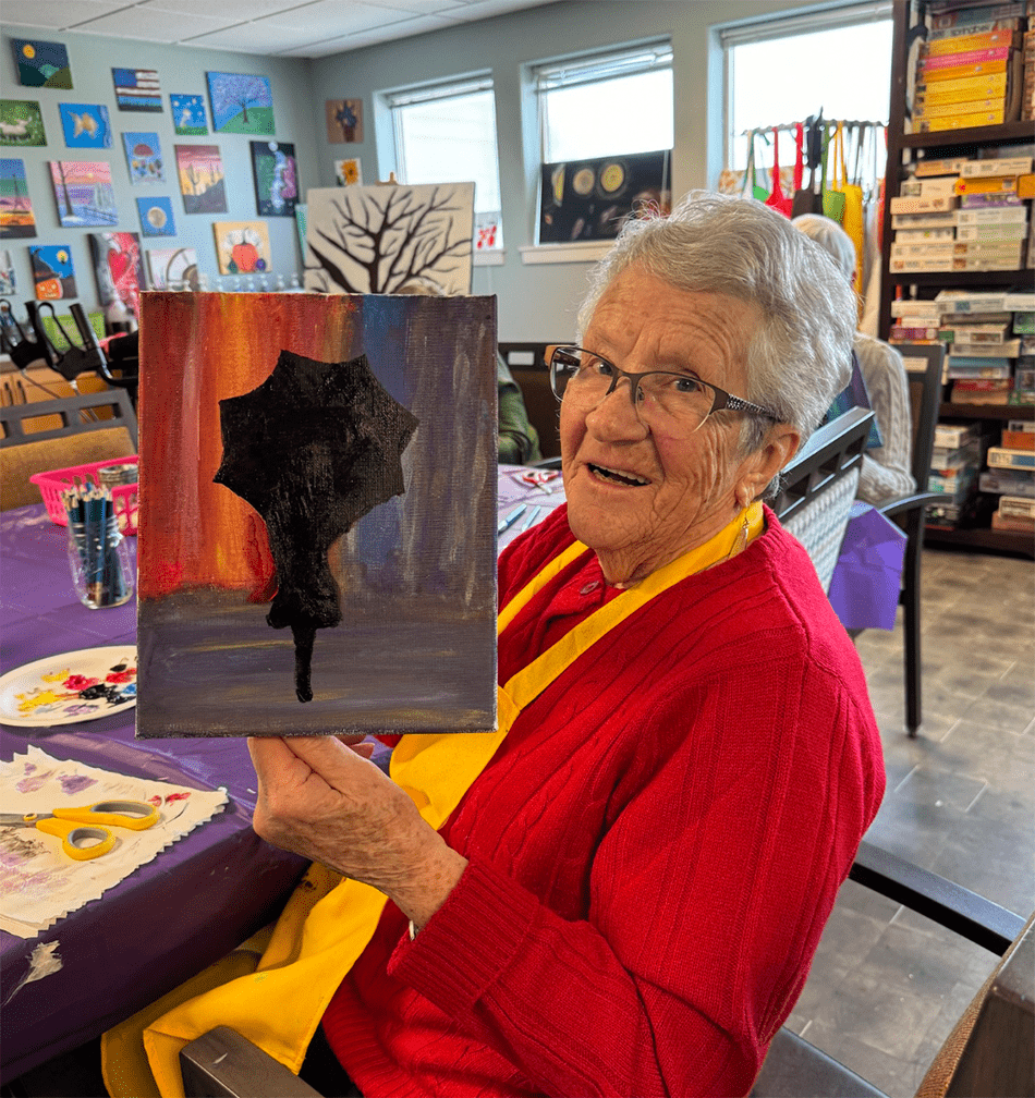 Resident painting in an activity room