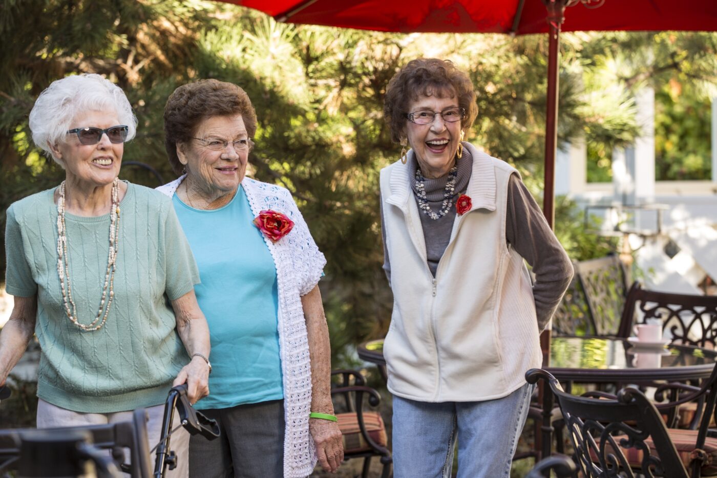 Three residents enjoying a sunny outdoor gathering