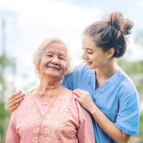 Nurse helping a senior resident outdoors