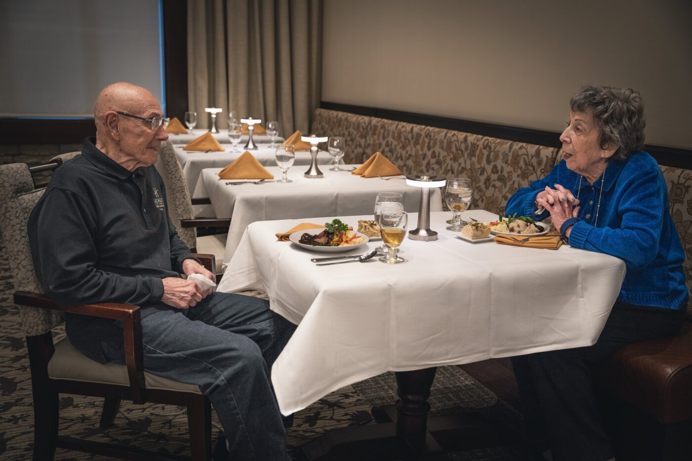 Two residents enjoying a meal in a dining room