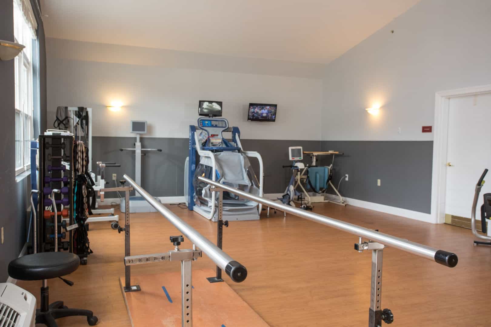 Interior view of a physical therapy room with exercise equipment