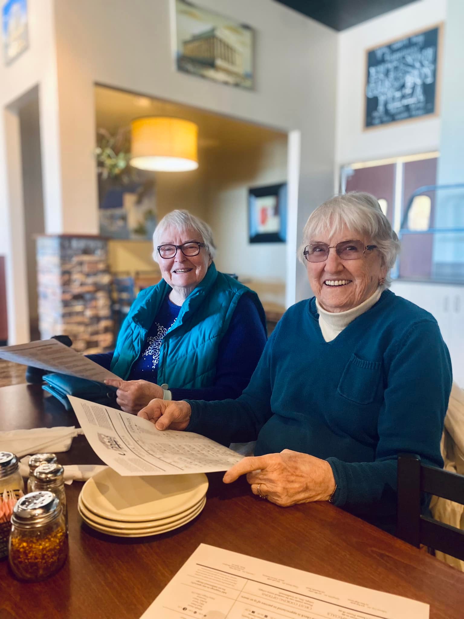 Two residents enjoying a meal in the dining area