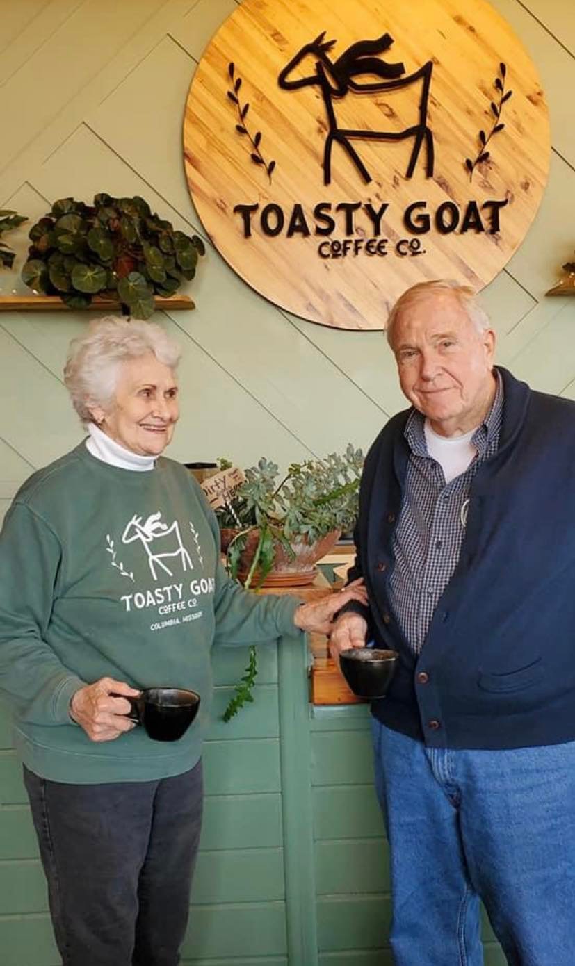 Two elderly residents enjoying coffee together in a cozy café