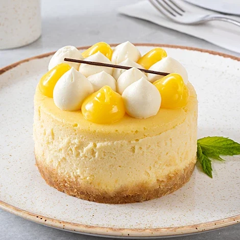 A slice of lemon cheesecake with decorative toppings