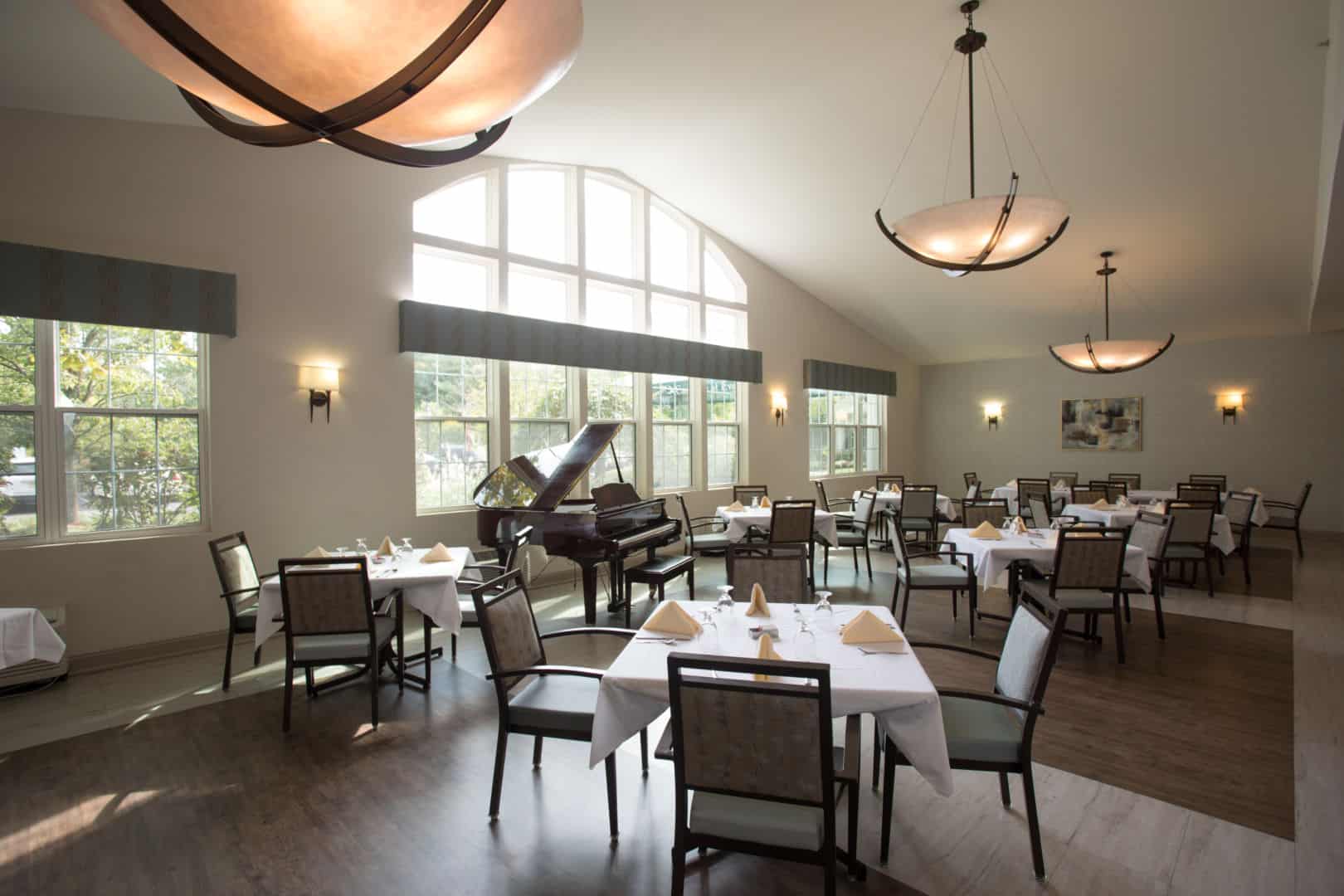 Elegant dining room with tables and a grand piano