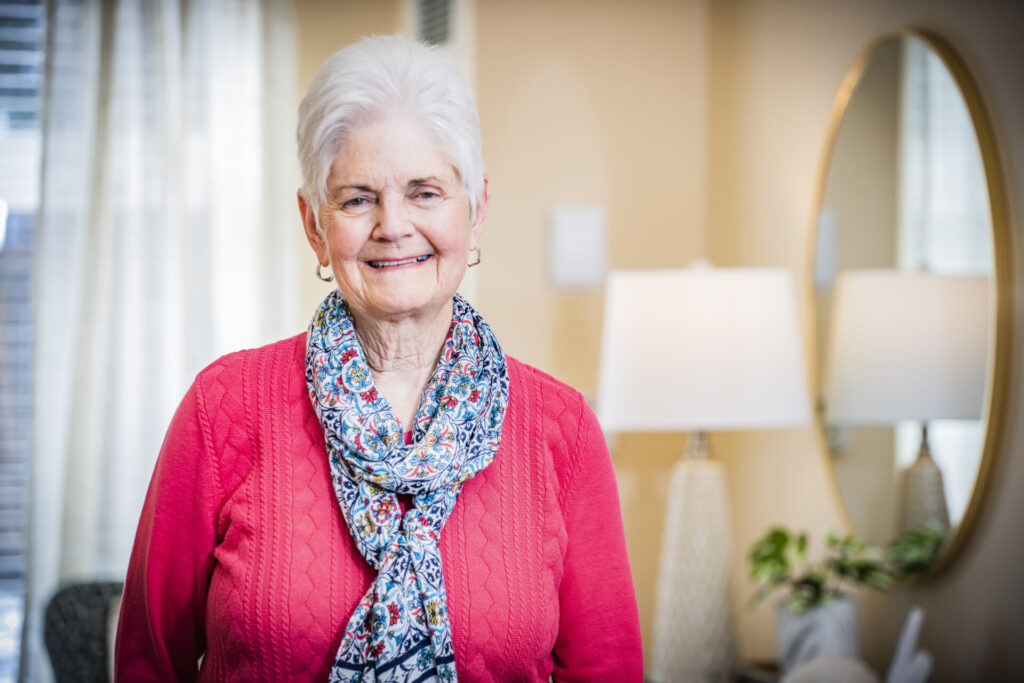A resident in a bright interior setting with natural light.