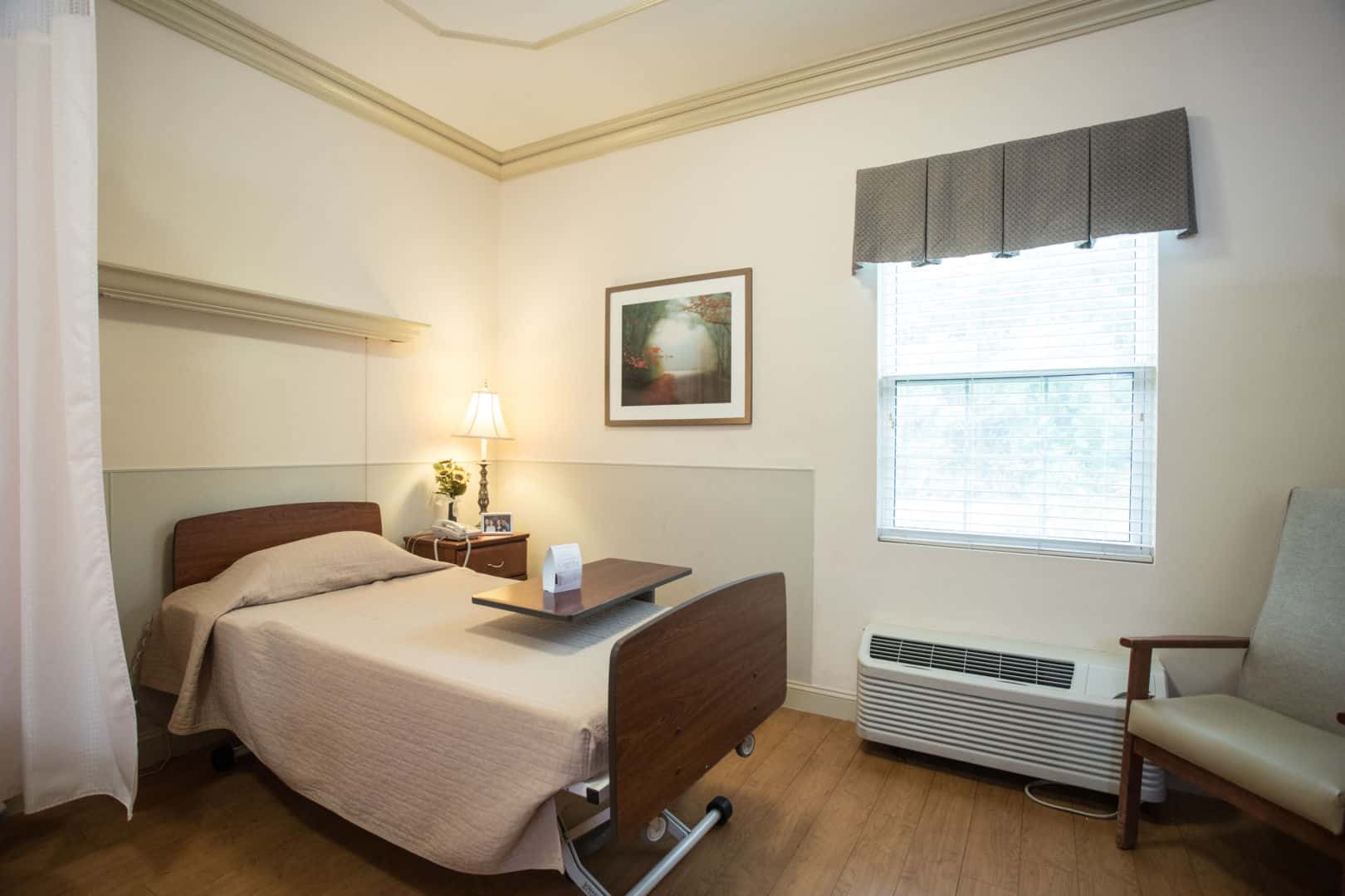 A private resident room with a bed and window