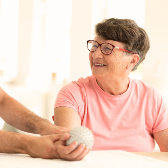 Resident engaged in a therapeutic activity with staff member