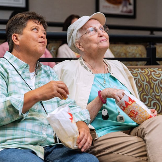Residents enjoying popcorn in a common area