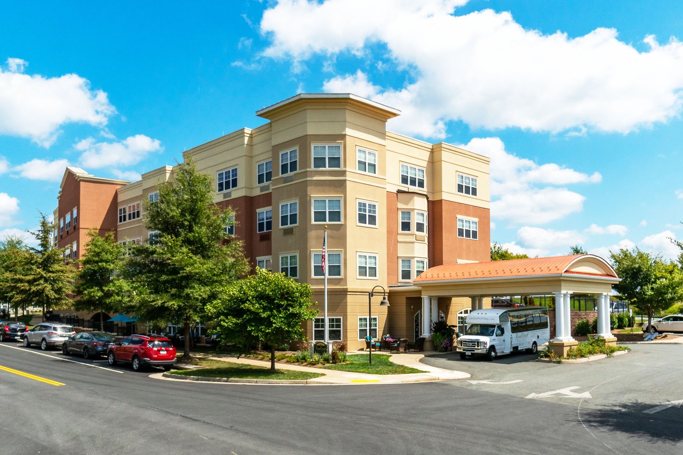 Exterior view of the Alto Overland Park facility with a shuttle bus