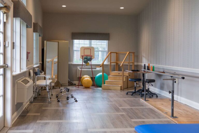 Physical therapy room with equipment and exercise tools