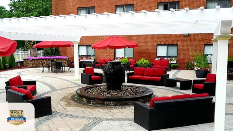 Outdoor seating area with red umbrellas and water fountain