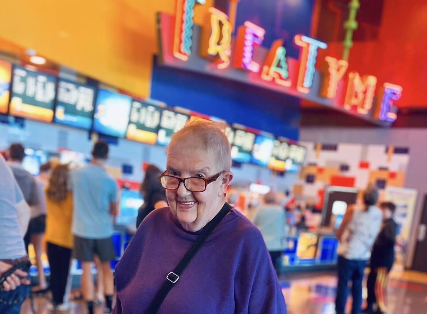 A smiling resident in a colorful indoor space