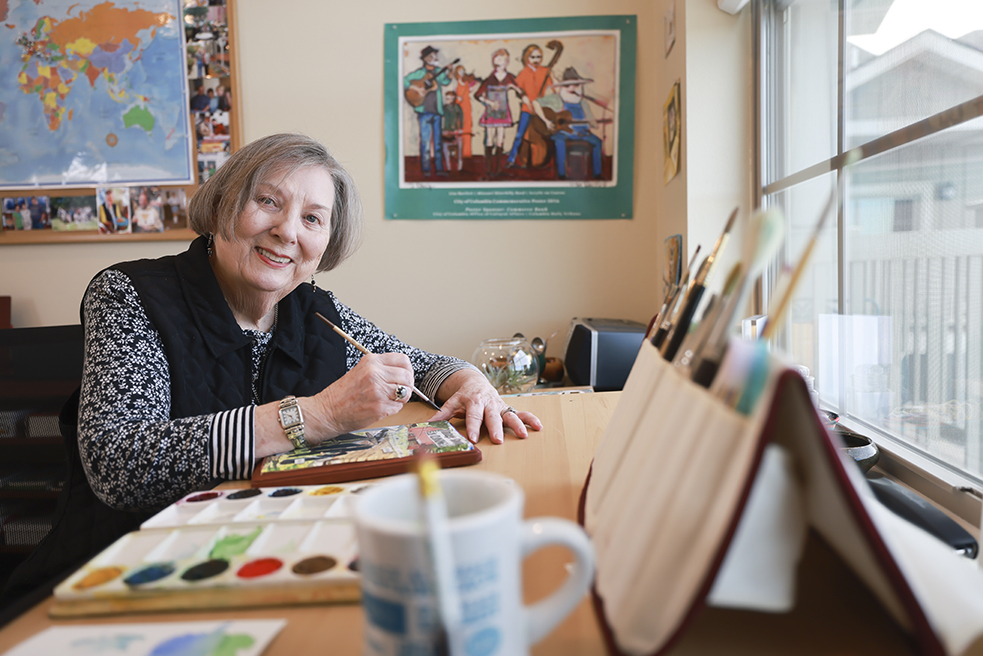 Senior resident painting in an arts and crafts room