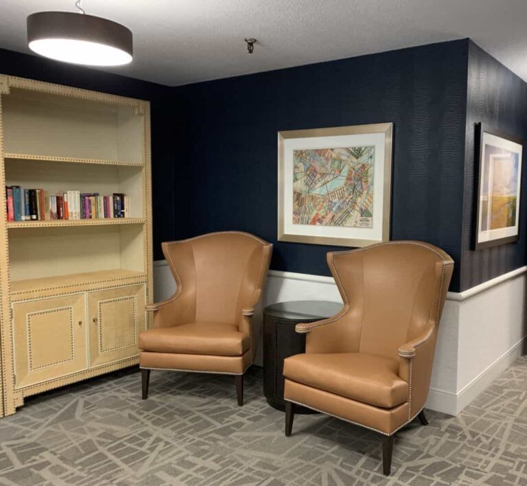 Cozy reading corner with armchairs and bookshelf