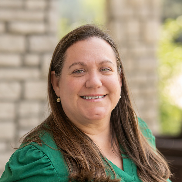 Staff member smiling outdoors