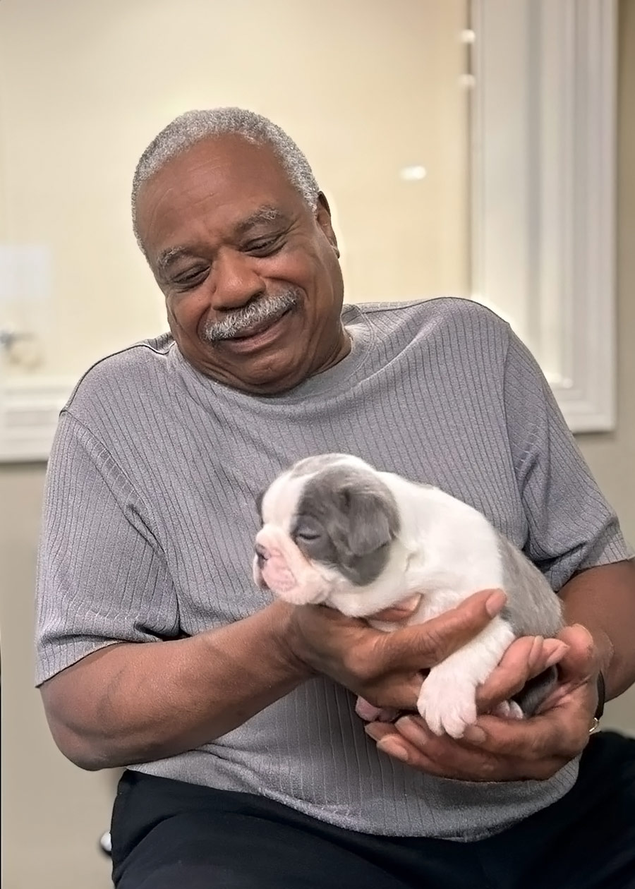 Resident holding a cute puppy in a cozy setting