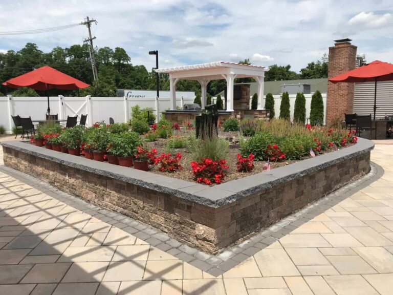 Beautiful outdoor garden space with red flowers and seating