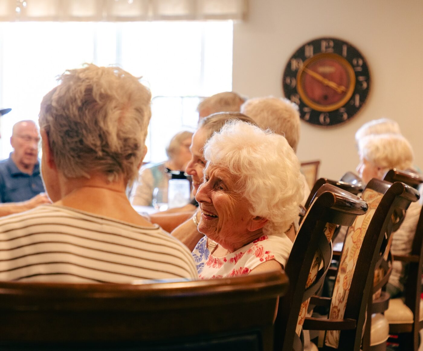 Residents enjoying a lively conversation in a common area