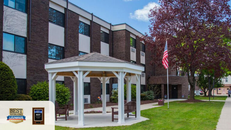 Exterior view of a senior living facility with outdoor seating