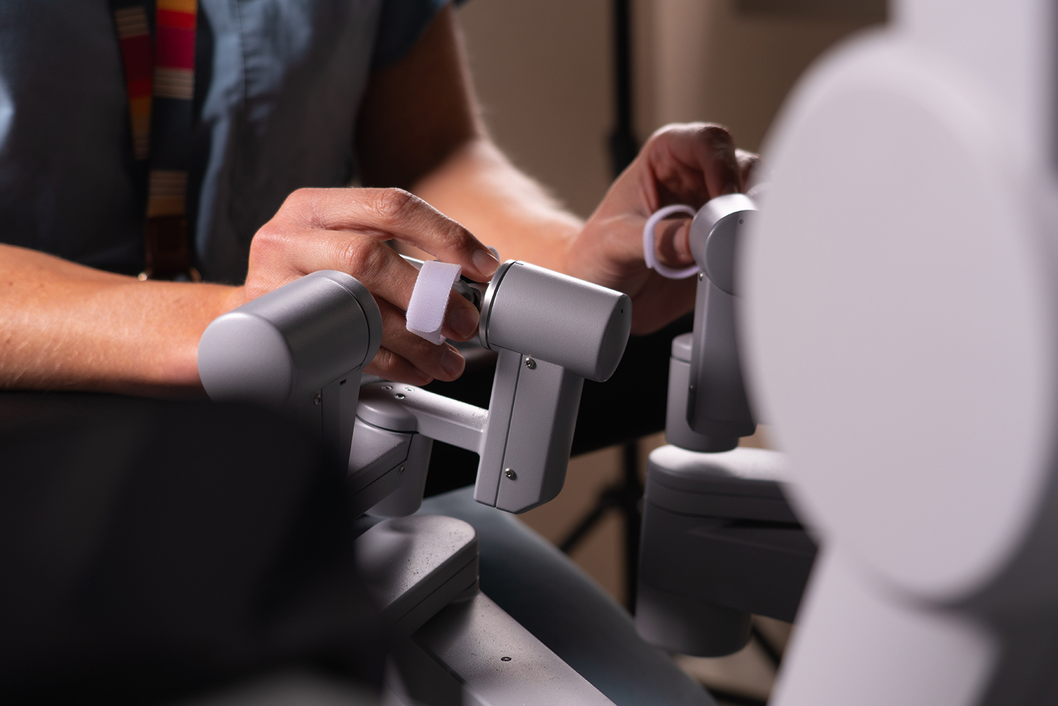 Close-up of hands adjusting medical equipment