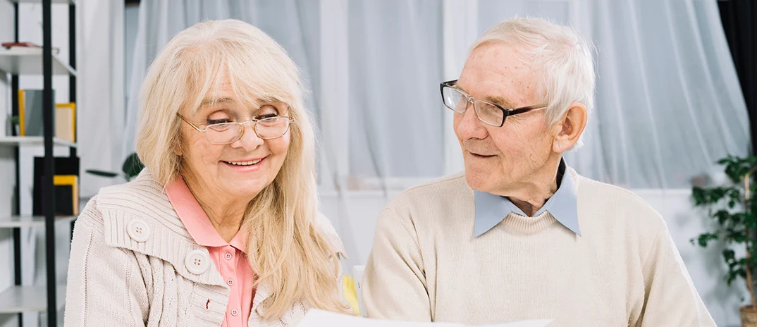 Two residents engaged in conversation at a table