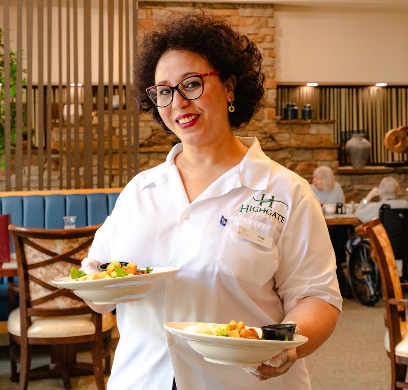 Staff member serving meals in the dining room