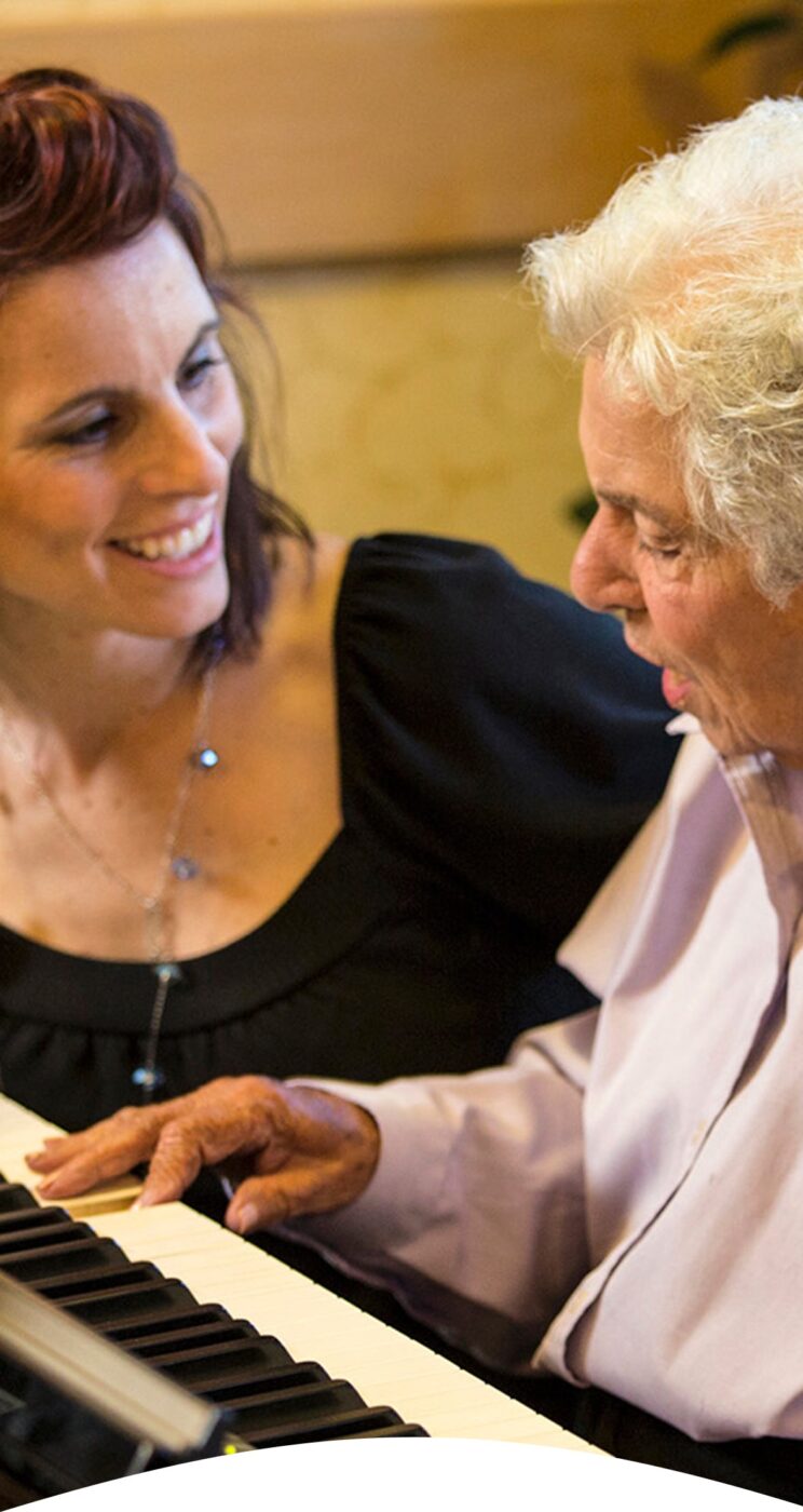 Resident and staff member enjoying a music activity